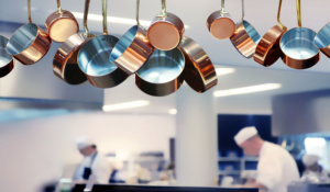 Kitchen Assistant cleaning pans